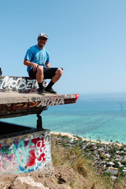 Sitting on the top of one of the Lanikai Pillboxes with the Pacific Ocean in the background 